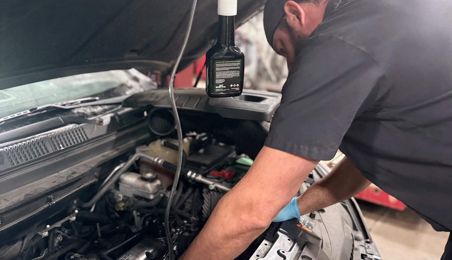 Technician checking vehicle fluids during preventive maintenance at Lonsbury Garage in Angola, IN