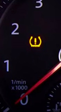TPMS warning light on dashboard indicating low tire pressure